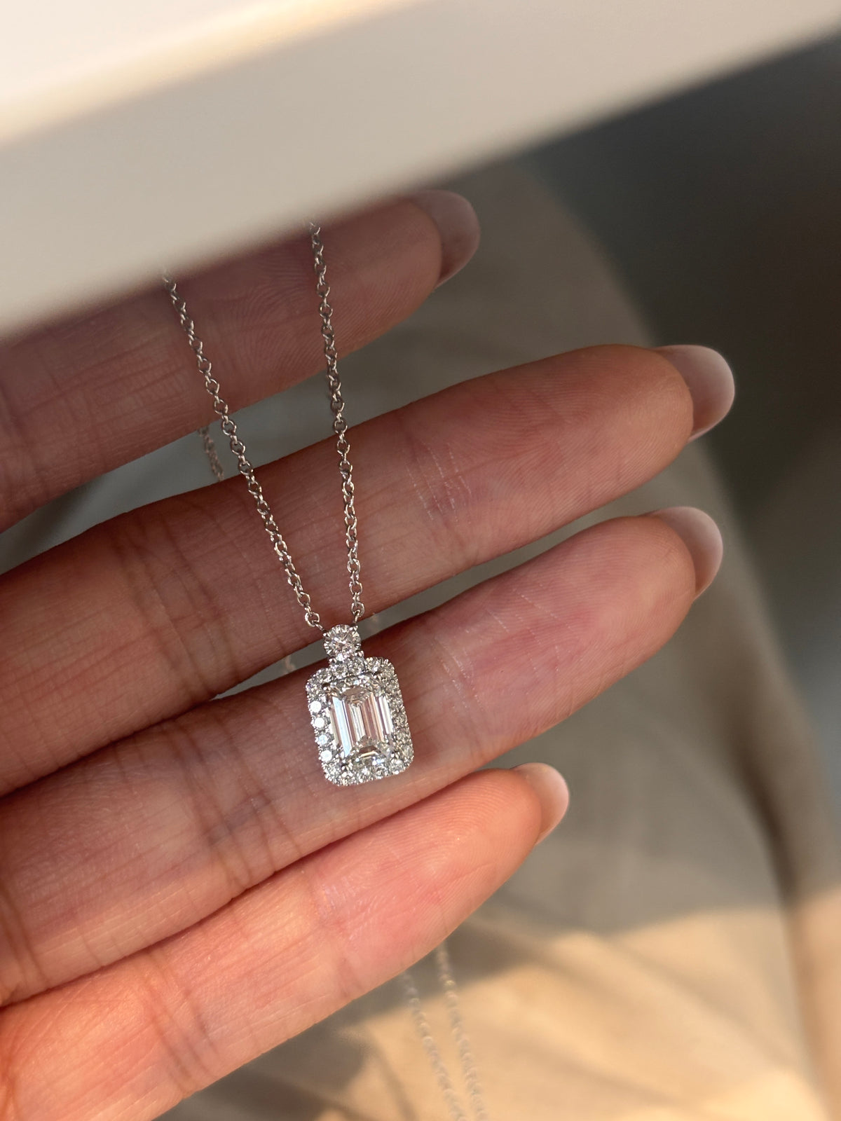The Casement emerald-cut halo & round diamond necklace, detail view — Highline Diamond