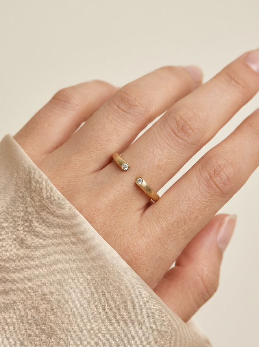 The Echo satin-brushed gold open cuff ring worn on hand