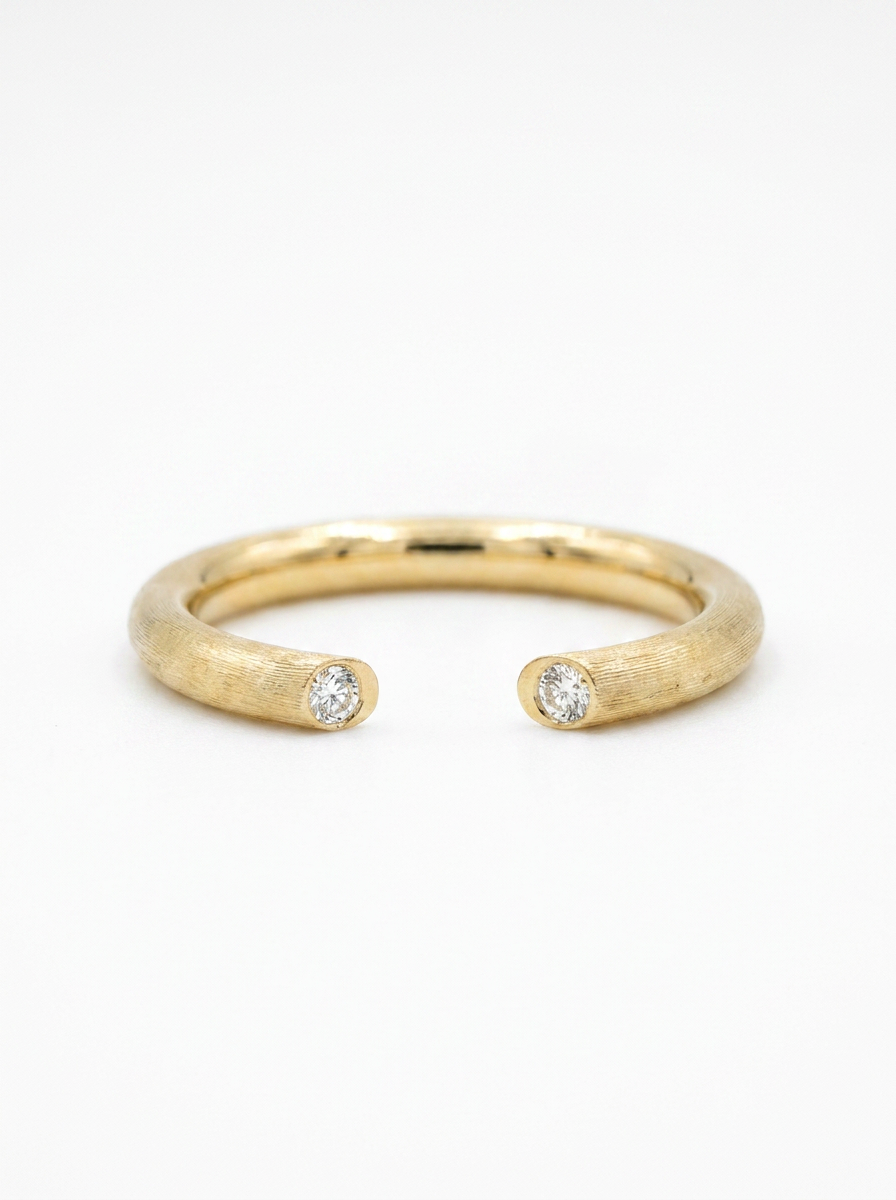 The Echo satin-brushed gold open cuff ring with twin bezel-set diamonds