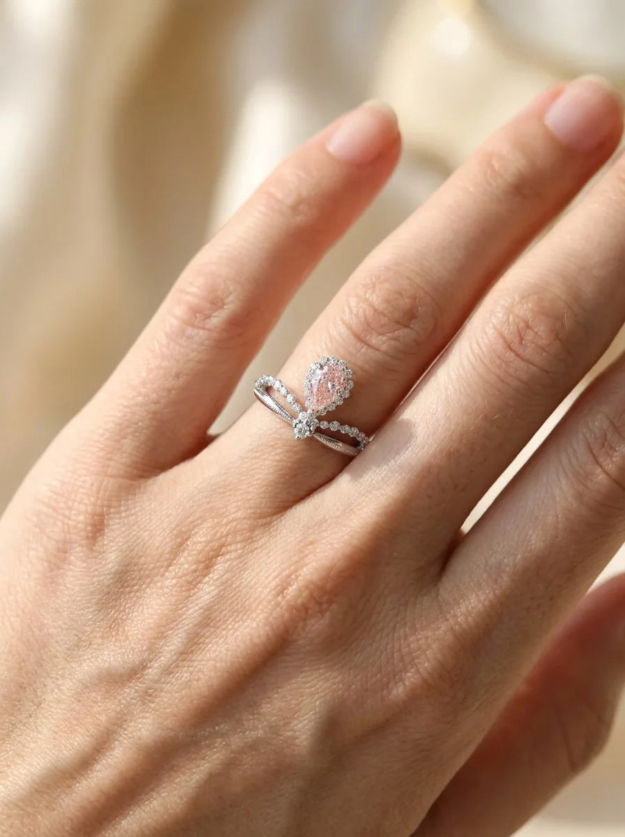The Aria suspended pink pear and diamond arch ring